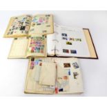 Three early/mid-20th century stamp albums containing a quantity of world stamps to include