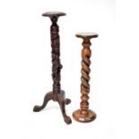 Two modern mahogany plant stands in the antique style, the largest with a shaped circular top,