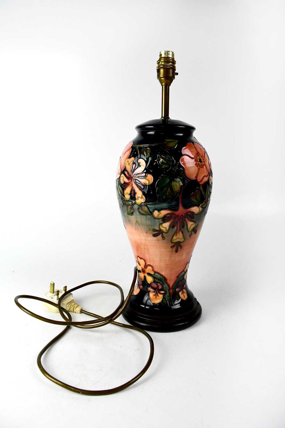 MOORCROFT; a large baluster lamp with tube lined 'Honeysuckle' pattern, on circular stepped base,