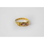 A 22ct yellow gold ring set with central small diamond flanked by two small rubies, size N,