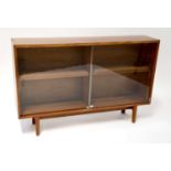 BEAVER & TAPLEY LTD; a mid-20th century teak glazed bookcase with pair of sliding doors enclosing