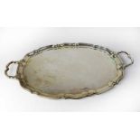 A George V hallmarked silver twin-handled tray with scalloped edge and double scroll handles,