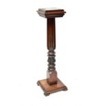 A carved mahogany jardinière stand with fluted turned column and acanthus leaf decoration, with a