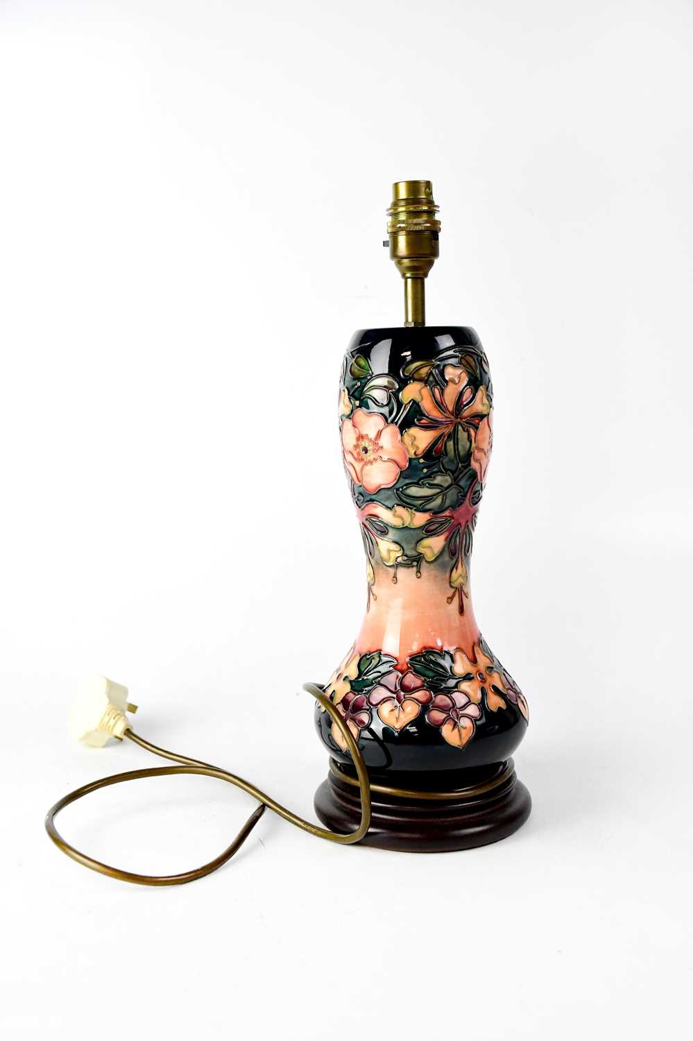 MOORCROFT; a waisted baluster lamp in tube lined 'Honeysuckle' pattern, to circular stepped base,