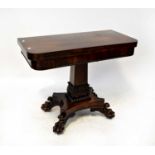 A Victorian rosewood fold-over table to rectangular column support with carved acanthus leaf