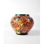 MOORCROFT; a baluster vase with mulitcoloured ground, with tube lined decoration, marked to base,