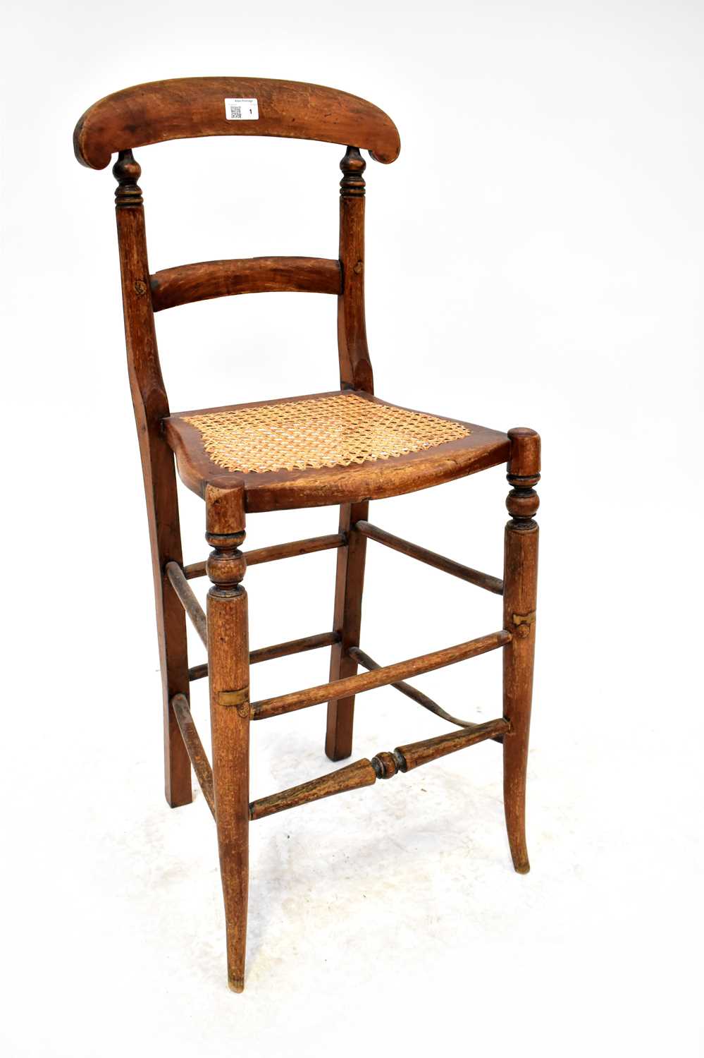 A child's late 19th century tall correction chair with rattan seat, turned supports, united with