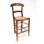 A child's late 19th century tall correction chair with rattan seat, turned supports, united with