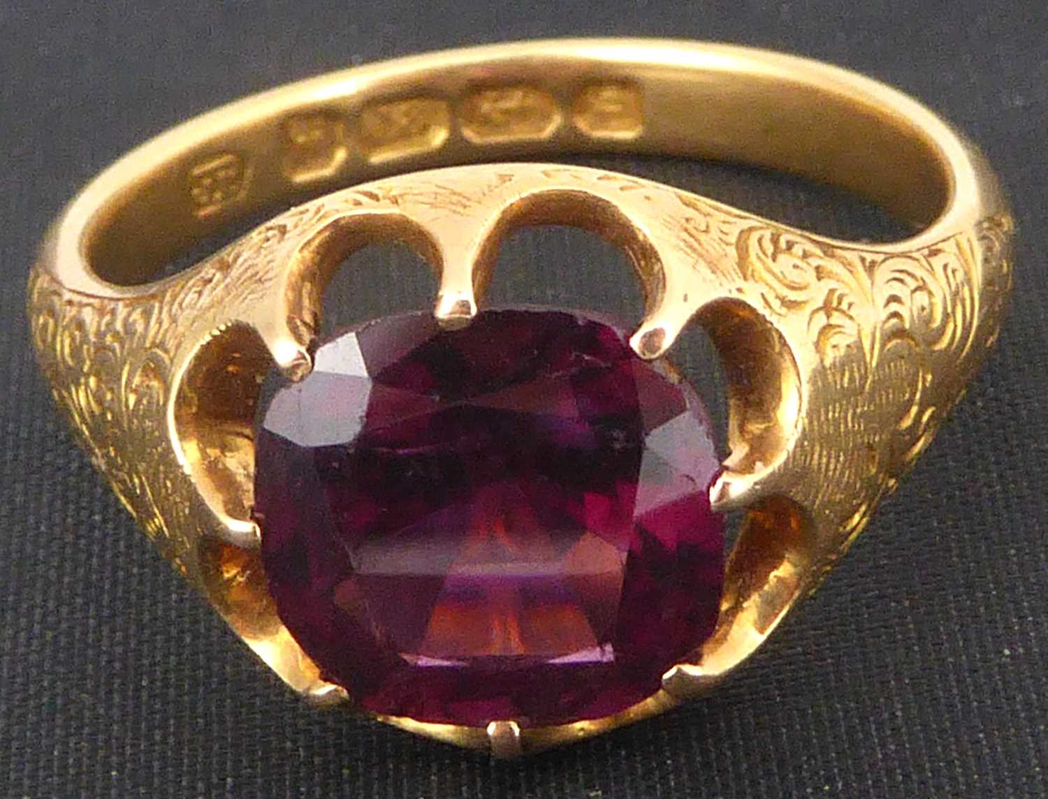 An 18ct gold amethyst ring with claw set square cut amethyst, with patterned shoulders, size R,