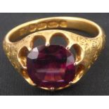 An 18ct gold amethyst ring with claw set square cut amethyst, with patterned shoulders, size R,