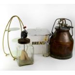 Five kitchenalia items comprising a copper milking apparatus with screw-down lid, a glass butter