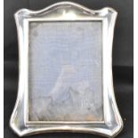 An early 20th century hallmarked silver tabletop photograph frame with wooden back, William Neale,