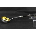 A silver soup ladle with gilt inner bowl, pin dot initials 'JAR' over 'CR' to the lower handle and