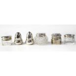 A hallmarked silver miniature salt and pepper, three small dressing table pots with hallmarked