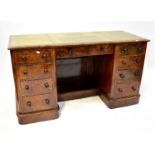 An early 20th century mahogany framed kneehole desk with faux leather and gilt tooled insert to