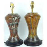 COBRIDGE; a near-matching pair of art pottery table lamps with brass fittings, on high-fired lava-