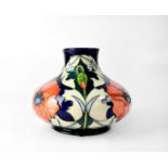 MOORCROFT; a squat onion form vase with poppy pattern decoration, height 16cm, numbered to the