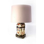 A gilt-heightened Imari palette hexagonal table lamp on pierced brass base, height excluding fitting