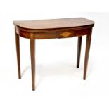 A 19th century mahogany demi-lune fold-over tea table with boxwood inlay, on square tapering legs,