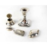 Various hallmarked silver items comprising a squat candlestick, a lidded inkwell, small lidded