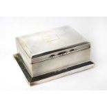 A hallmarked silver engine turned cigarette box with vacant cartouche, marks rubbed, 5 x 13.5 x