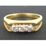 An 18ct gold three-stone claw set diamond ring, total approx. 0.21ct, size I, approx. 3.3g.