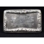 A Victorian hallmarked silver snuff box with raised floral border to the lid with inscription '