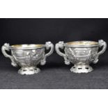 A pair of early 20th century Chinese silver salts in the form of cups decorated with people and