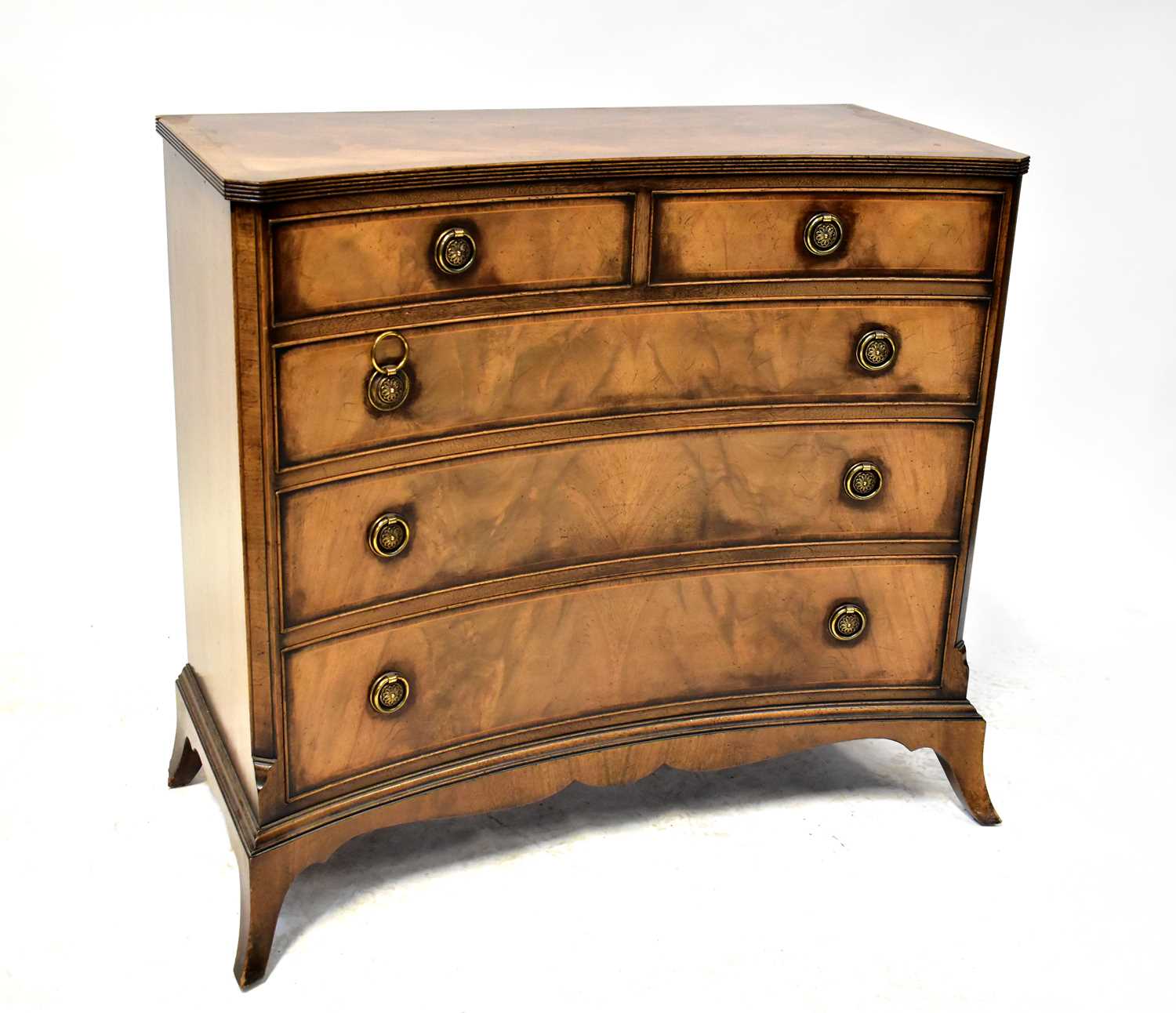 A mahogany reproduction chest of two small over three graduated drawers, with concave front and