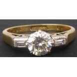 An 18ct gold diamond ring, the principal brilliant cut stone approx. 0.5ct, with diamond baguette