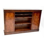 A 20th century bookcase cabinet with two central shelves, cupboard door to either side, with
