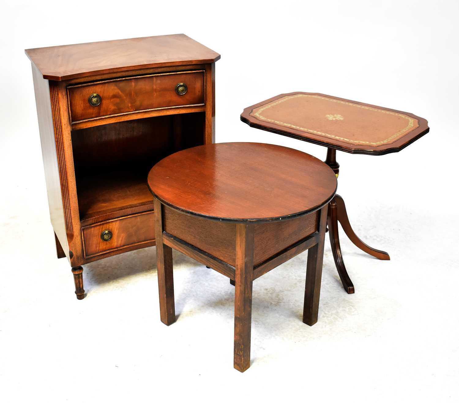 Three pieces of furniture to include a bedside table with shaped top, ring-handled drawer, central