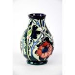MOORCROFT; a baluster vase with green ground and tube lined 'Poppy' pattern, initialled to base,