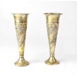 A pair of hallmarked loaded trumpet vases with repoussé floral and garland decoration, with