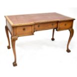A mid-20th century oak breakfront desk with faux brown leather insert, single central drawer to