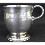 A George V hallmarked silver children's mug, decorated with a band depicting gnomes working in a