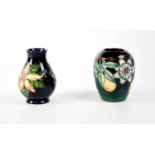 MOORCROFT; a baluster vase, green drip glaze ground with tube lined 'Passionflower' pattern,