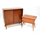 BEAVER & TAPLEY; a 1960s retro teak bookcase with pair of panelled sliding doors enclosing a