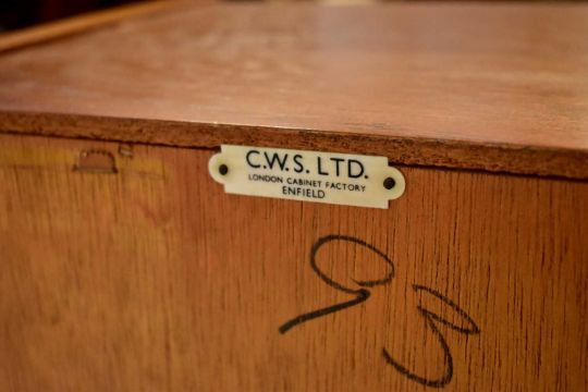 C.W.S. LTD; a 1960s retro teak bureau, fall front enclosing fitted interior  above a base of singl