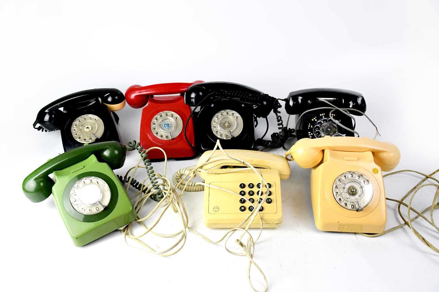 An assorted collection of telephones to include a green BT 8746, a black BT 706, a black GEC 746,