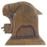 An early 20th century, possibly Scottish novelty wooden elephant cigarette dispenser, height 16cm.