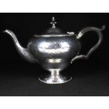 ROBERT CHANDLER; a George V hallmarked silver bachelor teapot with reproduction all-over hammered