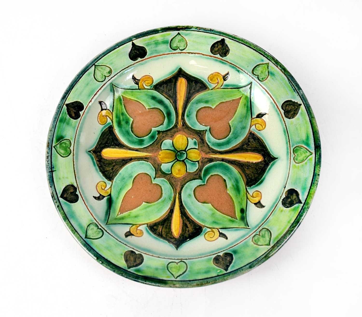 DELLA ROBBIA; an early 20th century plate, with green and brown ground and abstract leaf decoration,