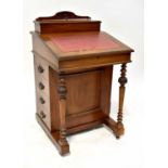 A 19th century mahogany Davenport with top stationery compartment, internal storage, four side and