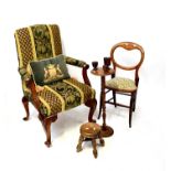 A mahogany framed armchair covered in plush fabric, with outswept arms, roundels and acanthus leaf