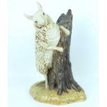 COBRIDGE POTTERY; a 'Bo Peep Sheep' pottery figure depicting a ewe on a tree stump, designed by