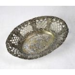 A German hallmarked silver pierced oval bowl, the centre repoussé decorated with putti within a