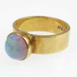 An 18ct gold contemporary opal ring, bezel set opal with greens and blues, size M/N, approx. 7g.