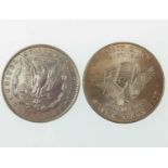 An 1886 peace silver dollar and 1981 fine silver (.999) trade unit (2).