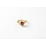 An 18ct gold cluster ring set with pear cut purple stone and diamonds, stamped 750, size O1/2,